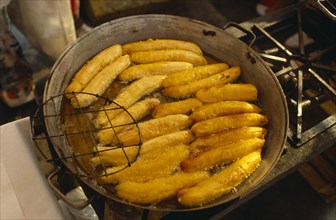 MEXICO, Mexico City, Fried bananas for sale on market stall.
