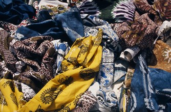 SENEGAL, Dakar, Local dyed and printed fabrics for sale in market.