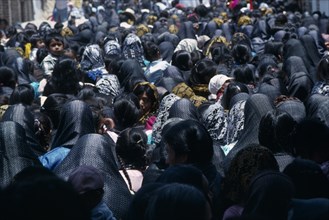 MEXICO, Oaxaca, "Crowds of women and children during Easter celebrations, many wearing black head