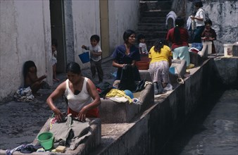 MEXICO, Work, Women scrubbing clothes in communal wash place.