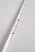 SCIENCE, Medical, Measurement, Detail of white mercury thermometer showing temperature scale and