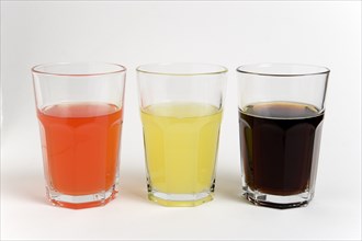DRINK, Soft Drinks, Sugar, "Soda glasses containing light red, yellow and dark coloured cola soft