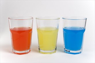 DRINK, Soft Drinks, Sugar, "Soda glasses containing light red, yellow and blue coloured soft