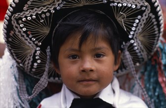 MEXICO, Puebla, Huejotzingo, Head and shoulders portrait of young boy dressed for carnival.