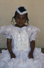 MEXICO, Oaxaca, Mitla, Portrait of young girl dressed in white on the day of her first communion.
