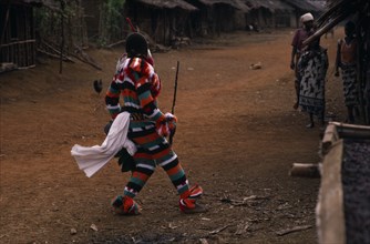 CAMEROON, South West, Rumpi Hills, Masked Ju-ju man wearing striped costume taking part in Leopard