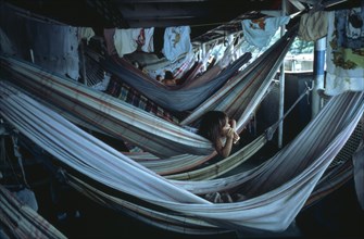 BRAZIL, Amazon, Transport, Child lying in hammock accommodation on Amazon river boat between Belem