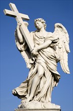 ITALY, Lazio, Rome, White marble statue of a winged female angel holding a cross on the Ponte Sant