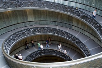 ITALY, Lazio, Rome, Vatican City People descending the spiral ramp from the Museum to the street