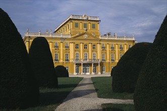 HUNGARY, Burgenland, Eisenstadt , Esterhazy Palace yellow painted exterior seen from formal gardens