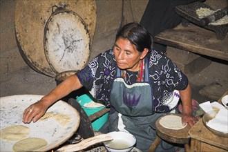 MEXICO, Chiapas, San Lorenzo Zinacantan, "Lady cooking tortillas, near San Cristobal de las Casas"