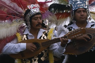 MEXICO, Mexico City, Musicians wearing elaborate feather head-dresses and costumes during Festival