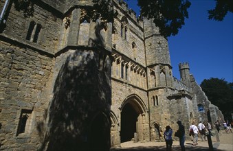 ENGLAND, East Sussex, Battle, Battle Abbey. Angled view of The Gatehouse seen from under tree