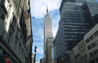 USA, New York, New York City, The Empire State building seen in-between tall buildings