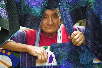 MEXICO, Chiapas, San Lorenzo Zinacantan, "Lady with colourful table mats, near San Cristobal de las