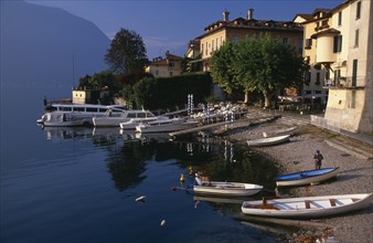 ITALY, Lombardy, Lake Como, Sala Comacina.  Fishing village with motor boats moored against wooden