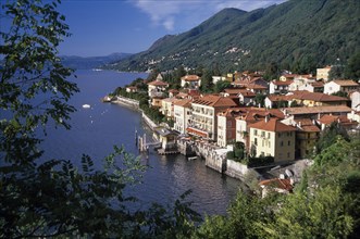 ITALY, Piedmont, Lake Maggiore, Cannero Riviera.  Waterside buildings with red tiled rooftops at
