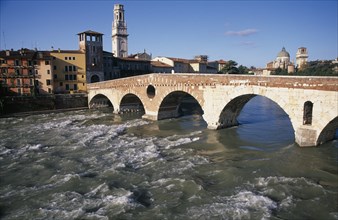 ITALY, Veneto, Verona, "Bridge across the River Adige with city buildings, tiled and domed rooftops