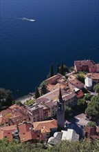 ITALY, Lombardy, Lake Como, "Varenna.  Looking down on red tiled rooftops, church and bell tower of