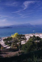 ITALY, Lombardy, Lake Garda , Sirmione.  View across Lake Garda from Villa Romana.  Flat outcrop of