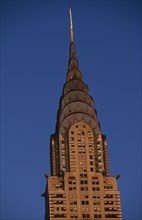 USA, New York, New York City, Part view of the Chrysler Building from East 42nd Street lit by