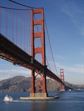 USA, California, San Francisco, The Golden Gate Bridge with a ferry traveling past on the water