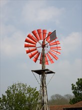 ENGLAND, West Sussex, Amberley, Amberley Working Museum. Orange wind vane pump