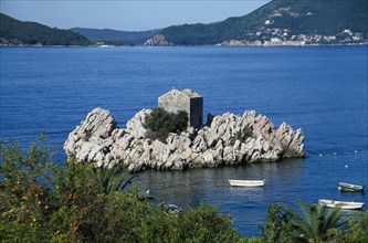 MONTENEGRO, Przno, Fortified building built into rock formation off the coast