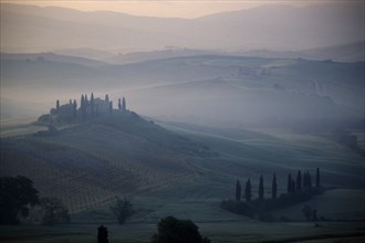 ITALY, Tuscany, San Quirico, View over The Belvedere in early morning mist