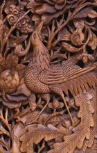 CHINA, Yunnan Province, Dali, "Detail of traditional door carving depicting bird, leaves and