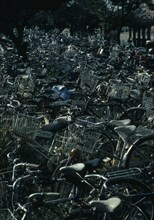 JAPAN, Honshu, Kyoto, Mass of commuter’s bicycles parked beside a station.