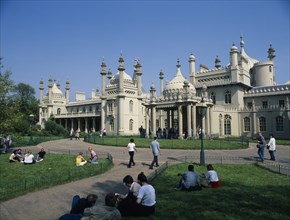 ENGLAND, East Sussex, Brighton, The Royal Pavilion seen from the gardens with visitors at entrance