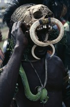 PAPUA NEW GUINEA, Highlands, People, Head and shoulders portrait of man wearing traditional