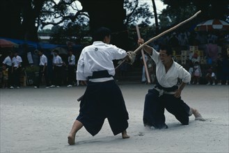 JAPAN, Kyushu, Kaseda, Villagers fighting with sticks replacing swords during the samurai festival