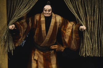 JAPAN, Arts, Performance, Bunraku puppet male character appearing from behind curtains with