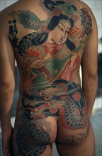 JAPAN, People, Yakuza, Cropped shot of heavily tattooed back of gangster or Yakuza gang member in
