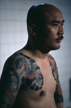 JAPAN, People, Yakuza, Three-quarter shot of gangster or Yakuza gang member in public bath house