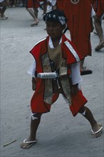 JAPAN, Kyushu, Kaseda Shrine, Young boy wearing traditional costume and carrying short sword at