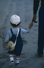 JAPAN, People, Children, "Young child seen from behind, wearing white cap and short trousers