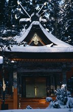 JAPAN, Honshu, Wakayama, "Mount Koyosan.  Shinto shrine in thick layer of snow over roof, ground