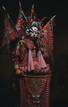 CHINA, Shanxi, Taiyuan, "Performer in traditional Chinese opera wearing elaborate red and blue