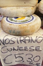 ITALY, Lake Garda Area, Display of nostrano cheeses for sale with price in euros.