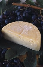 ITALY, Lake Garda Area, Tremosine cheese and grapes used in locally produced Bardolino wine.