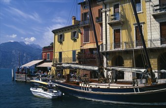 ITALY, Veneto, Malcesine, "Yellow, white and terracotta painted facades of waterside buildings with