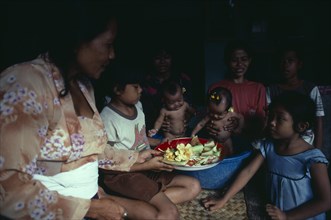 INDONESIA, Bali, Kuta, "Family group with twin babies.  In Bali, village people see the birth of