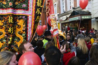 ENGLAND, London, Chinatown, Red and yellow lanterns hanging above Gerrard Place and a banner