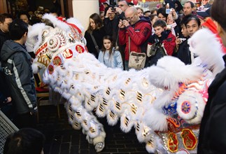 ENGLAND, London, Chinatown, Lion Dance troupe and embroidered banners in Gerrard Street amongst the