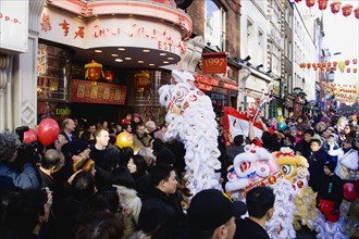 ENGLAND, London, Chinatown, Lion Dance troupe and musicians performing in Wardour Street amongst