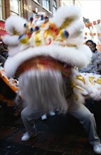 ENGLAND, London, Chinatown, Lion Dance troupe performing in Gerrard Street with onlooking crowd