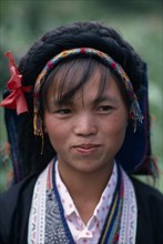 CHINA, Guizhou Province, People, Head and shoulders portrait of Bouyei girl in traditional dress.